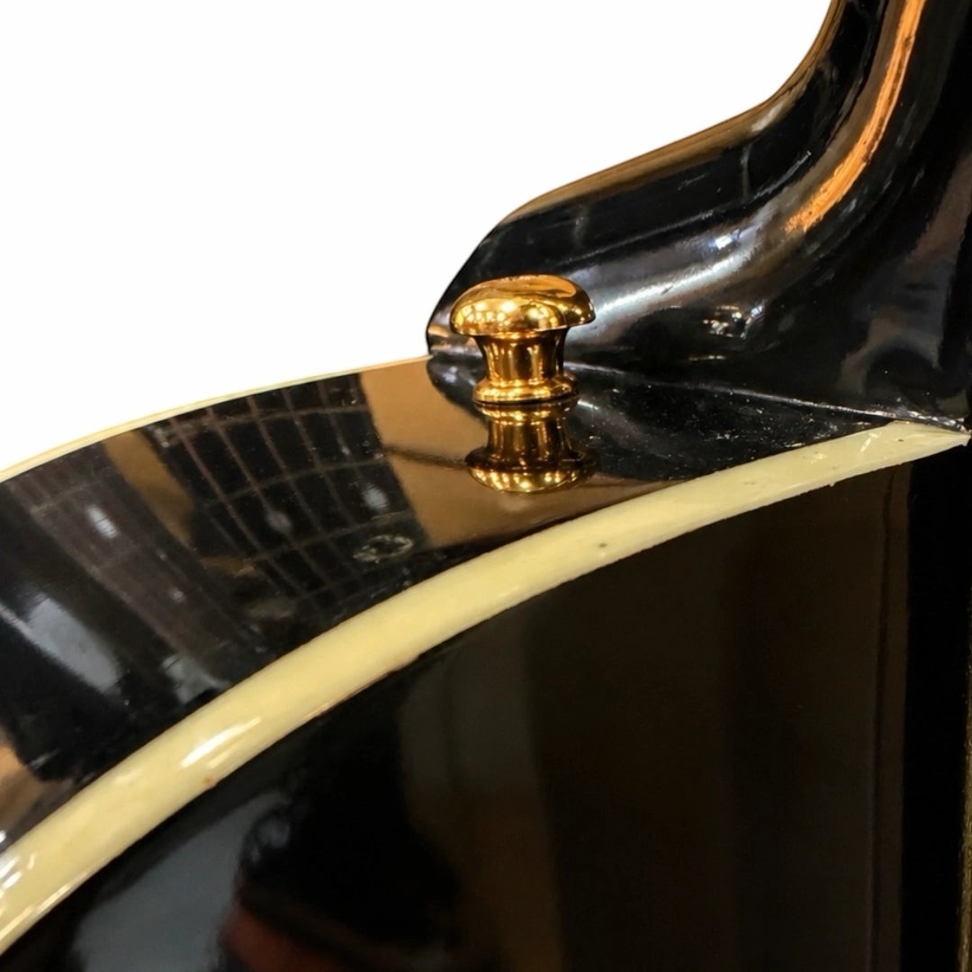 Prathmesh Music HT guitar strap lock in polished gold finish installed on a black electric guitar body